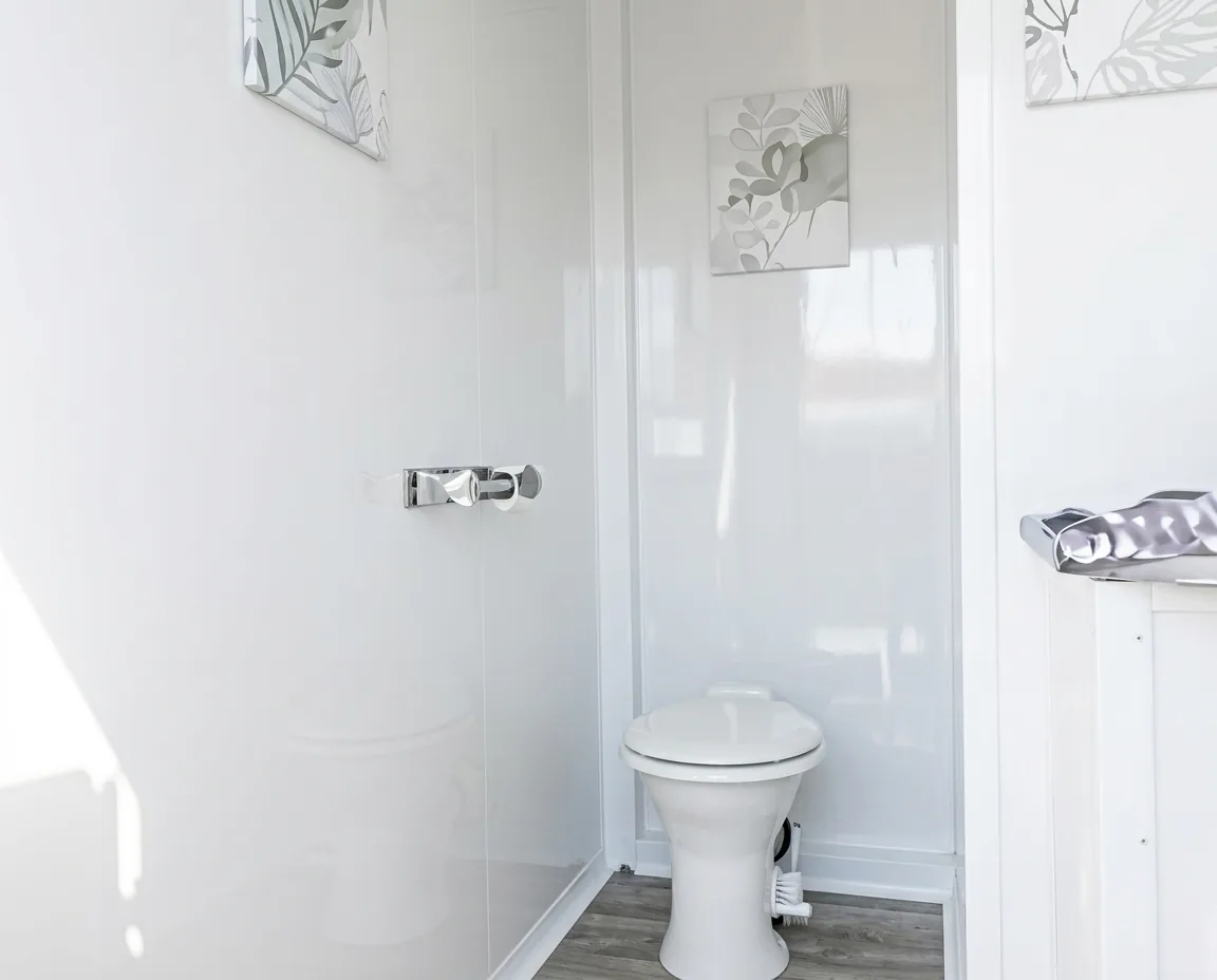 Example private restroom trailer stall finished in white